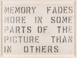 Words that read "MEMORY FADES MORE IN SOME PARTS OF THE PICTURE THAN OTHERS" stenciled in black on off-white background in white frame